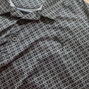 Puma gray golf polo with palm tree pattern